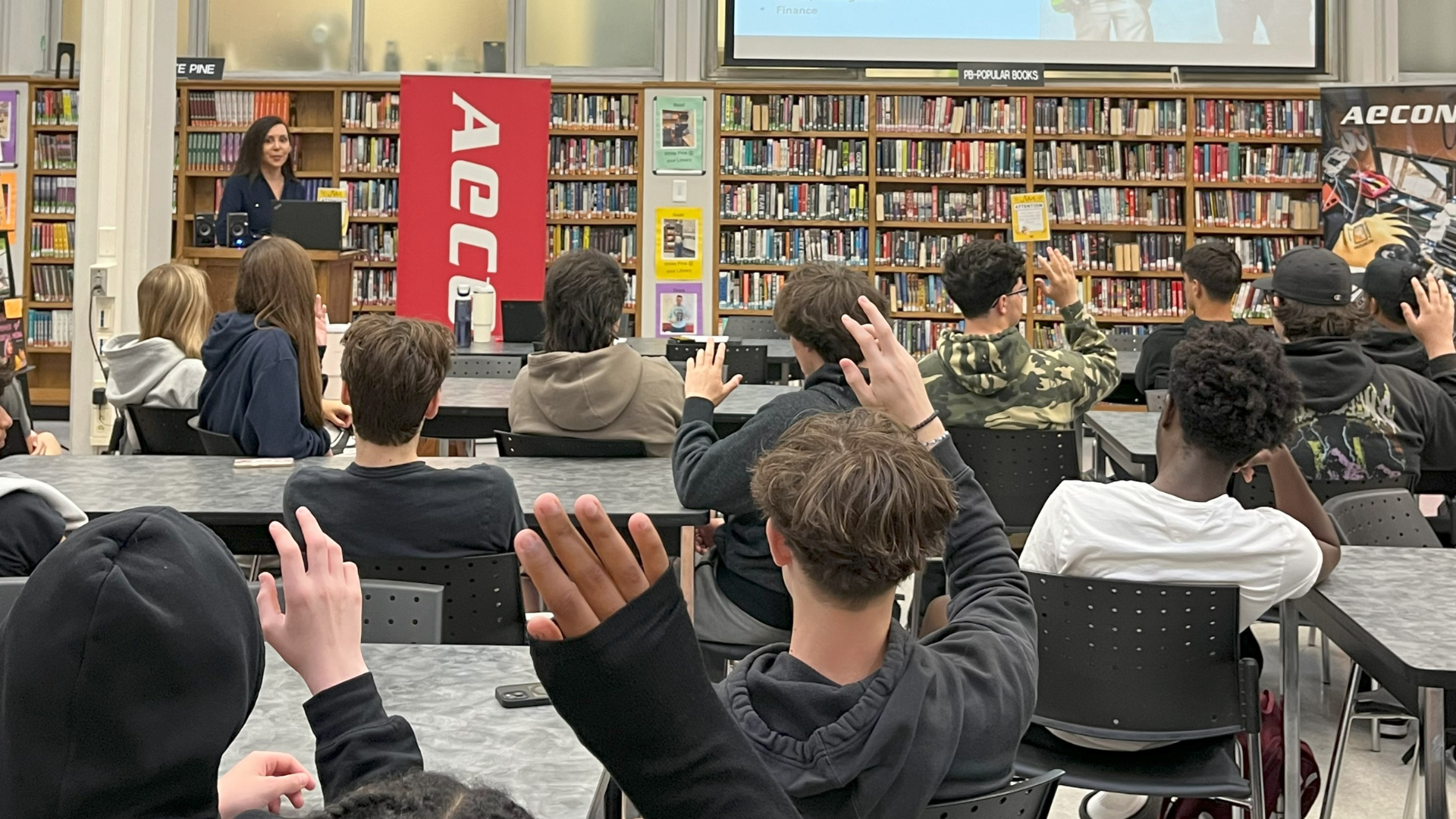Students raising their hand during a presentation