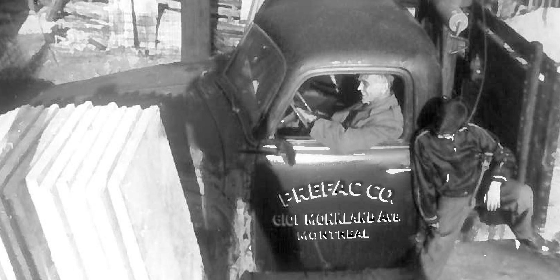 Black and white photo of man in a car
